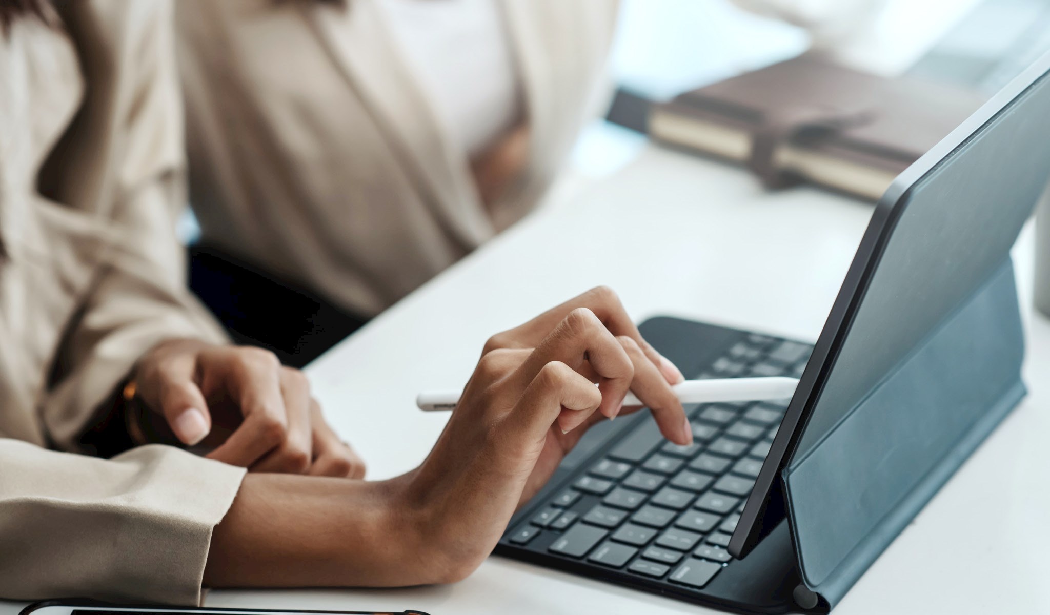 Hands pointing to a laptop